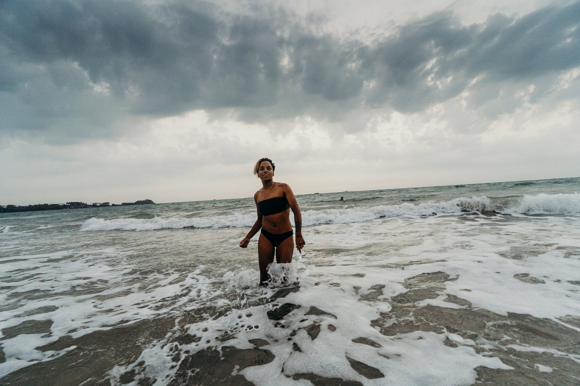 woman in black tank top and black shorts standing on baga beach goa